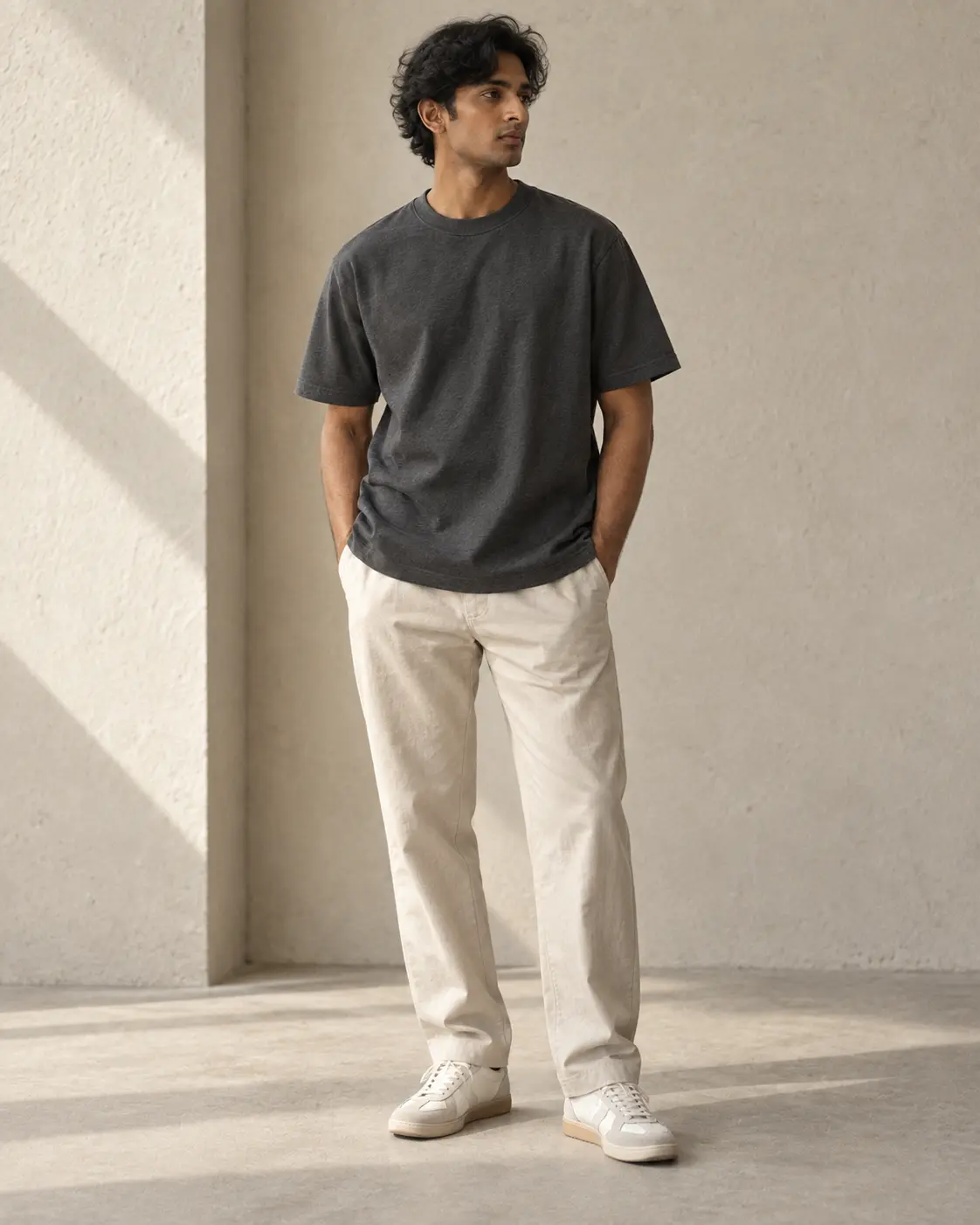Full-length Ative portrait featuring a substantial charcoal T-shirt